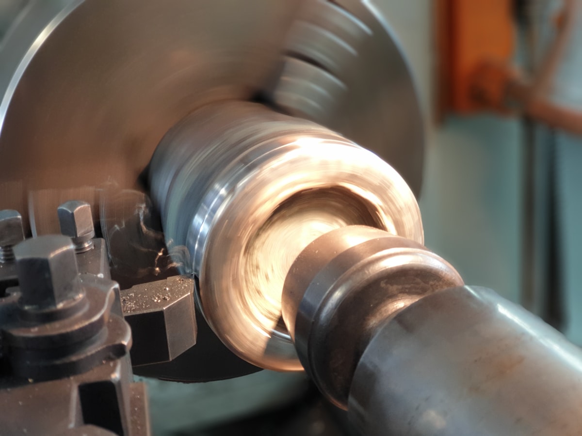 Lathe machining a metal drum, representative of Friction Materials Co.'s drum turning and rotor machining process